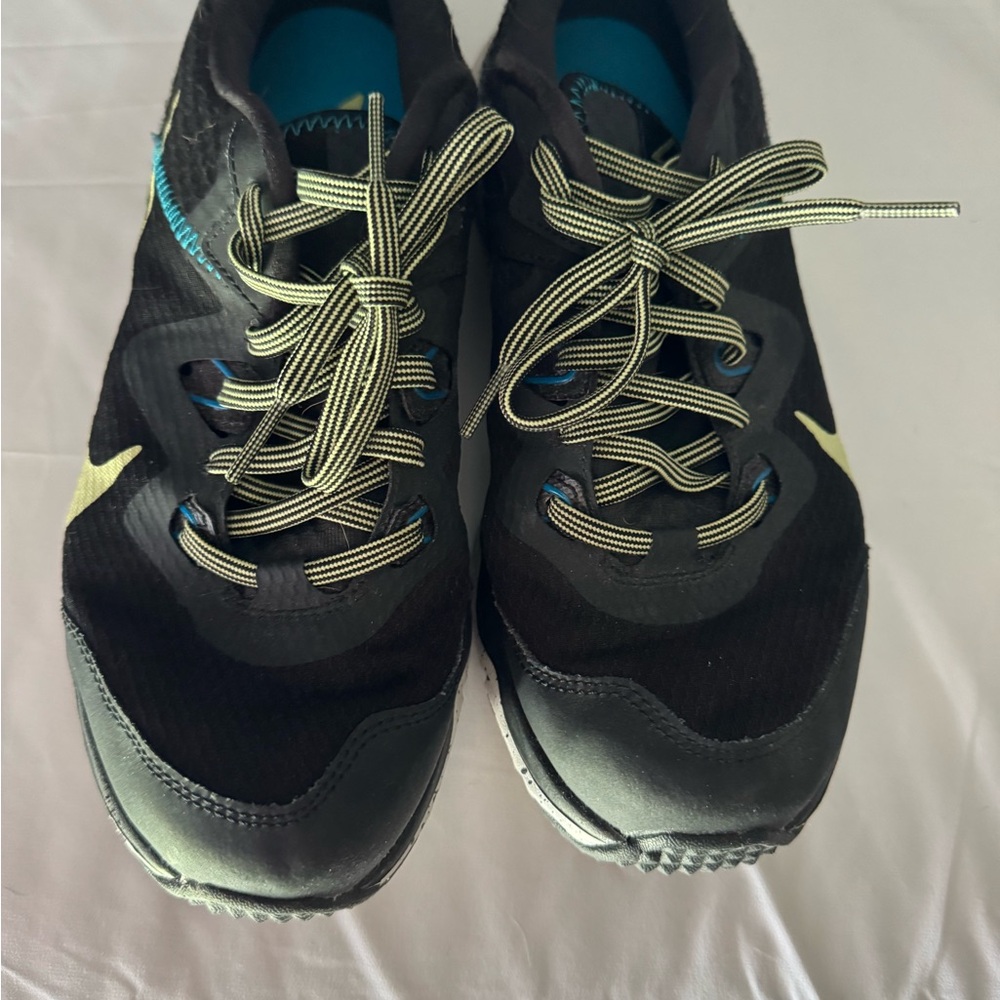 Woman’s Nike Black and Yellow with Blue Trim Athletic Shoes